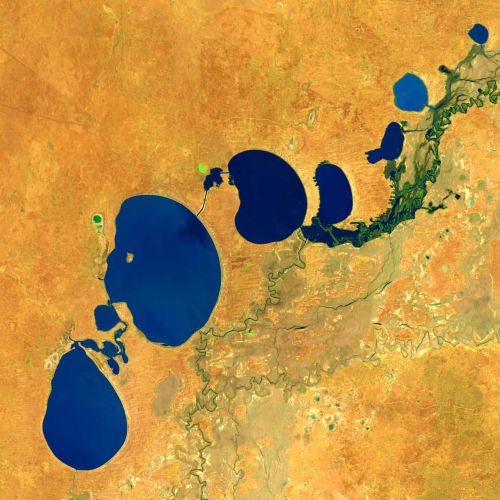 satellite image of lake system with emphasised blue lakes against yellow land